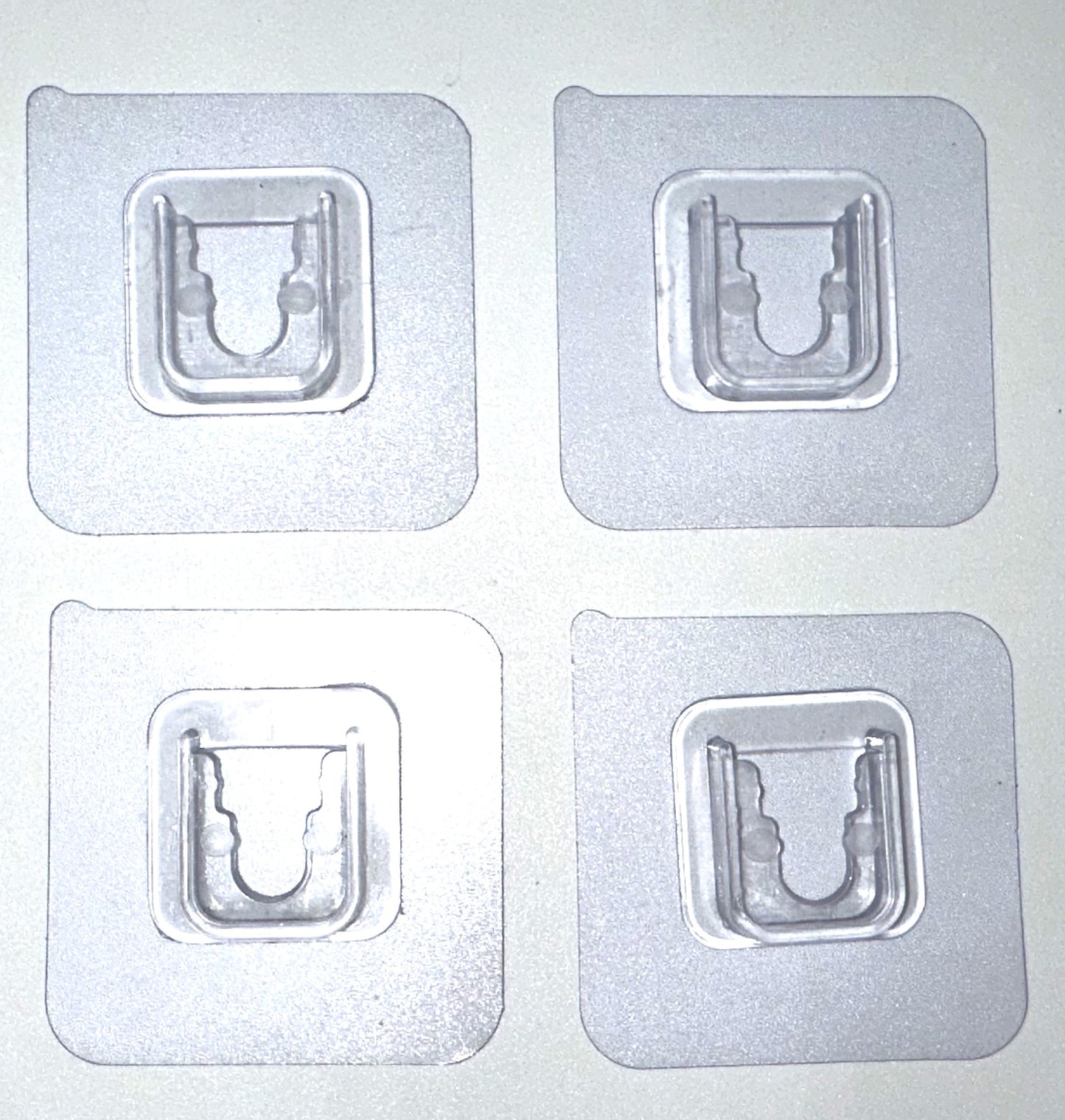 Branch holder -clear adhesive pads that sticks to the white PVC sides